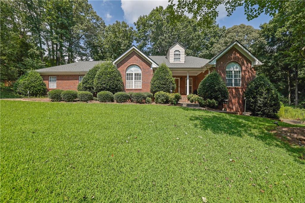4963 Weaver Road Gainesville, GA 30507 - Photo 1 of 1 a front view of a house with garden