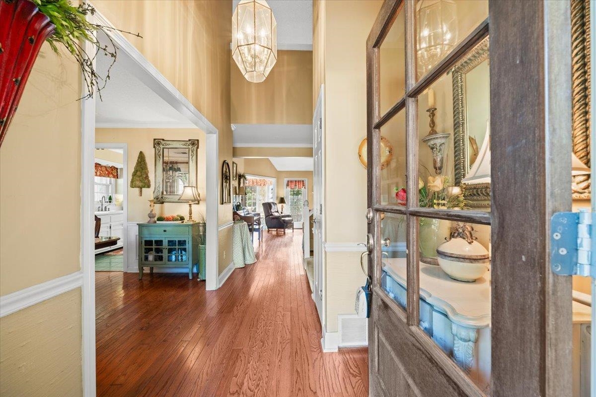 1880 Newfields Road Germantown, TN 38139 - Photo 12 of 34 Foyer with wood finished floors, a chandelier, ornamental molding, and a high ceiling