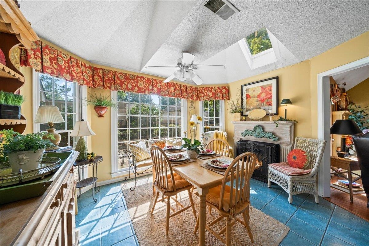 1880 Newfields Road Germantown, TN 38139 - Photo 18 of 34 Sunroom featuring tile patterned floors, a skylight, a textured ceiling, and vaulted ceiling