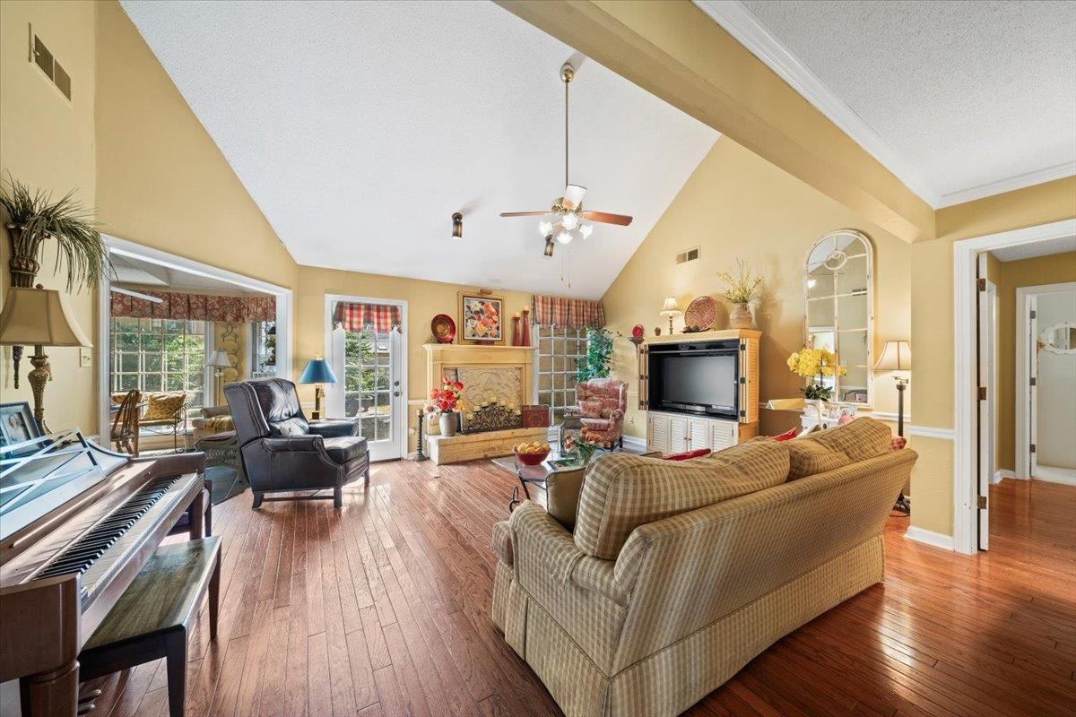 1880 Newfields Road Germantown, TN 38139 - Photo 20 of 34 Living area featuring hardwood / wood-style flooring, a textured ceiling, high vaulted ceiling, and a ceiling fan