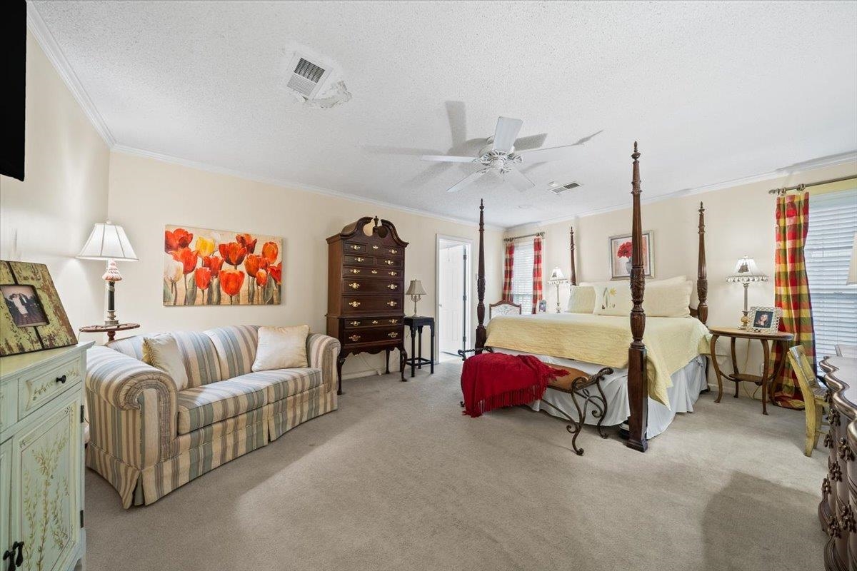 1880 Newfields Road Germantown, TN 38139 - Photo 21 of 34 Carpeted bedroom featuring a textured ceiling, crown molding, and ceiling fan