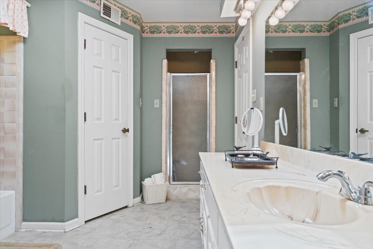 1880 Newfields Road Germantown, TN 38139 - Photo 23 of 34 Full bathroom with a stall shower, vanity, and a tub to relax in