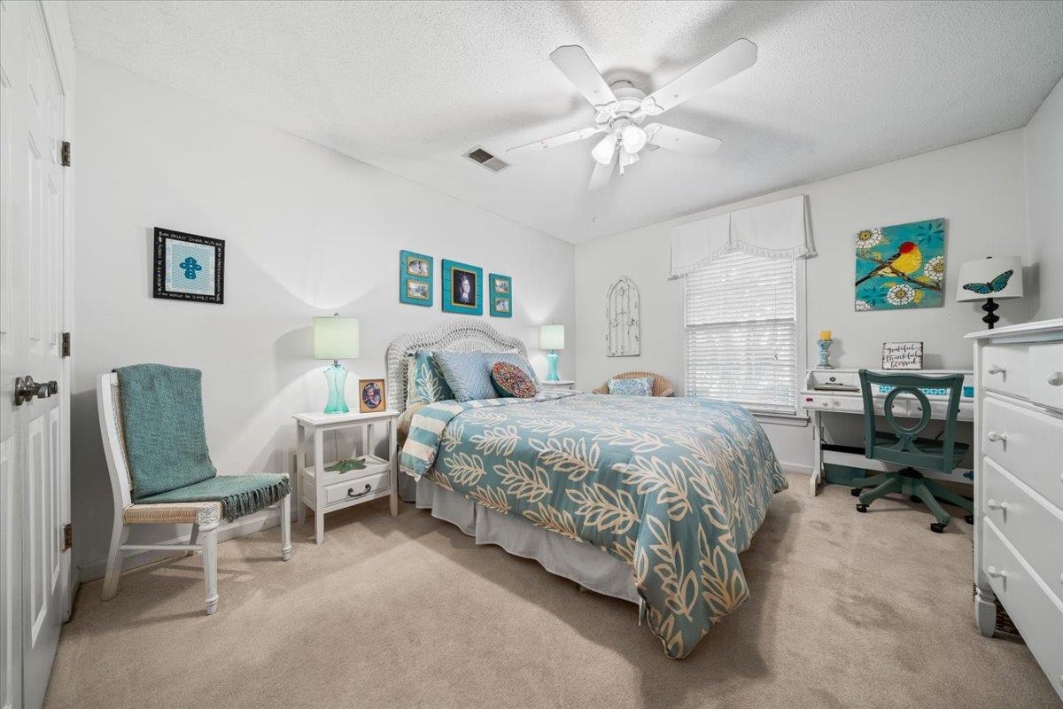 1880 Newfields Road Germantown, TN 38139 - Photo 24 of 34 Bedroom featuring light colored carpet, a textured ceiling, ceiling fan, an office area, and a closet