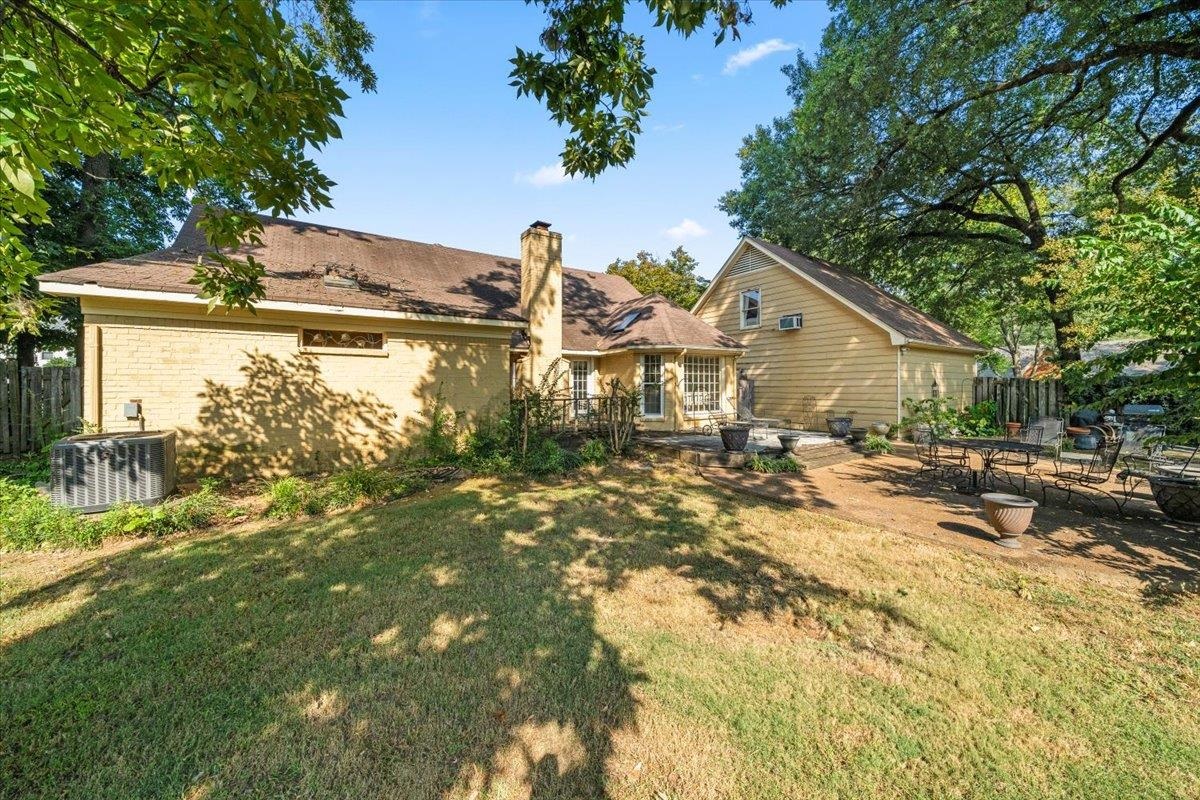 1880 Newfields Road Germantown, TN 38139 - Photo 33 of 34 Back of house featuring a patio, a chimney, and brick siding