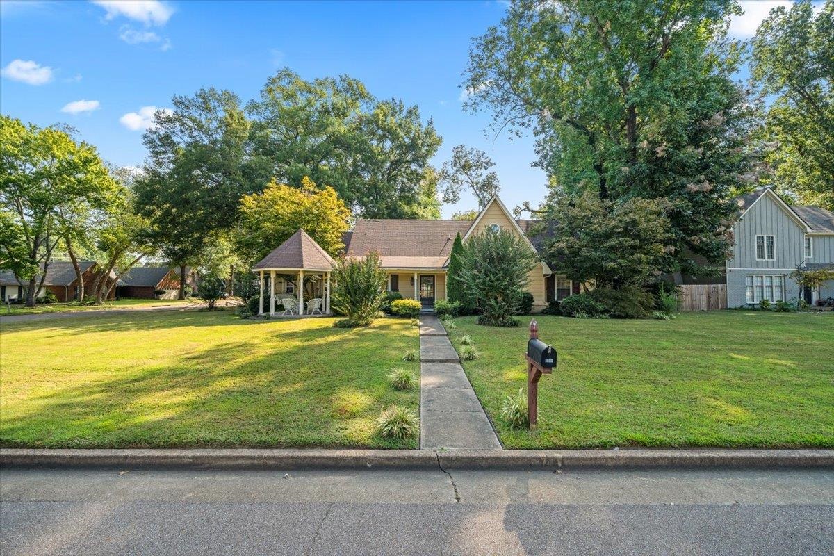 View of front of home with a porch and a front lawn