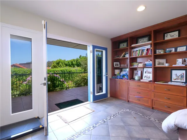 a bedroom with a bed and large mirror