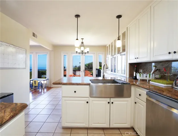 a kitchen with stainless steel appliances granite countertop a sink a stove and cabinets