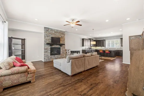 a living room with furniture kitchen view and a fireplace