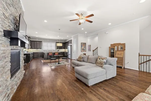 a living room with furniture and kitchen view