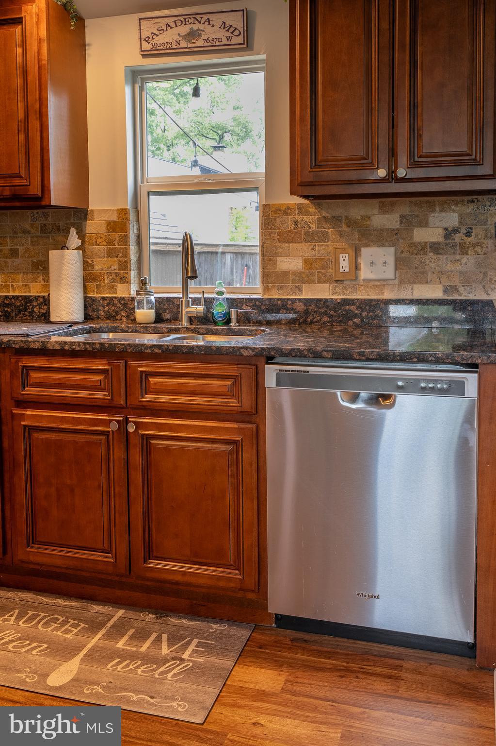1816 Cremen Road Pasadena, MD 21122 - Photo 9 of 46 a kitchen with granite countertop wooden cabinets a sink and a window