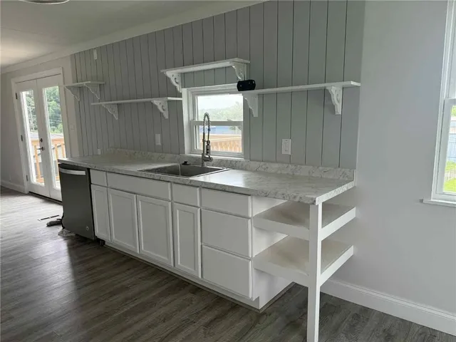a bathroom with a sink and mirror with toilet