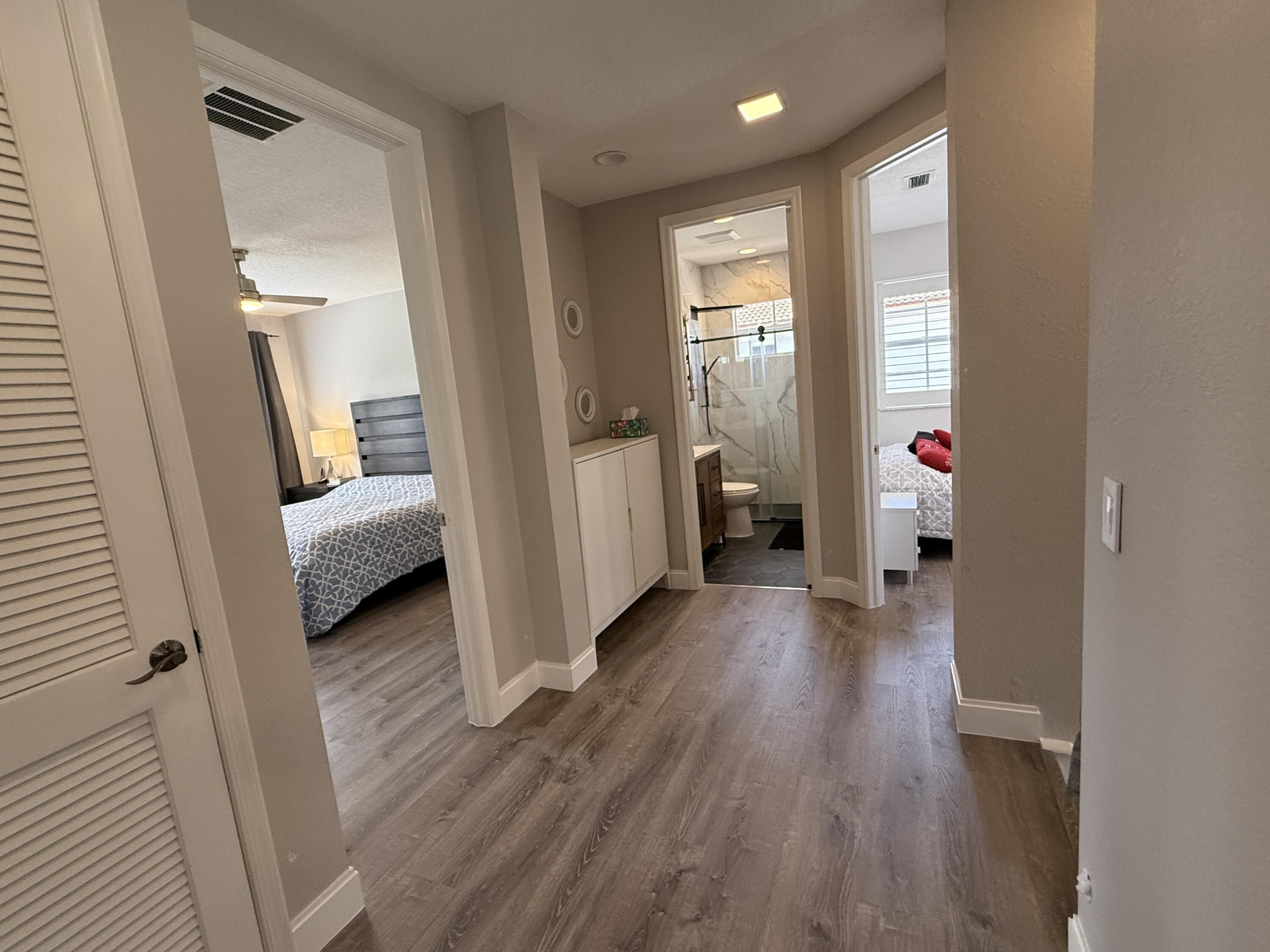 706 Duchess Court Palm Beach Gardens, FL 33410 - Photo 12 of 61 a view of a hallway view with wooden floor and furniture