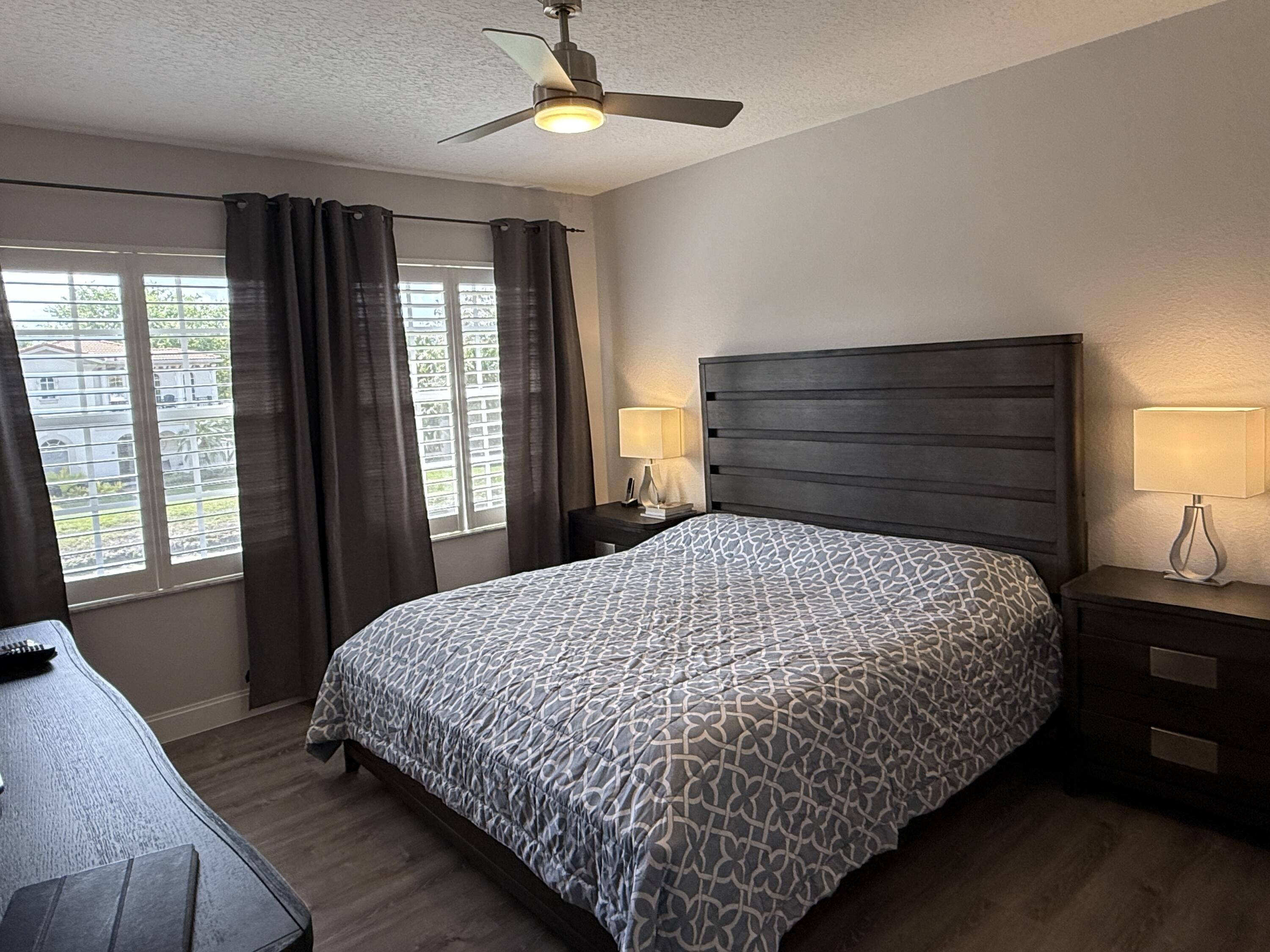 706 Duchess Court Palm Beach Gardens, FL 33410 - Photo 13 of 61 a bedroom with a large bed and a window