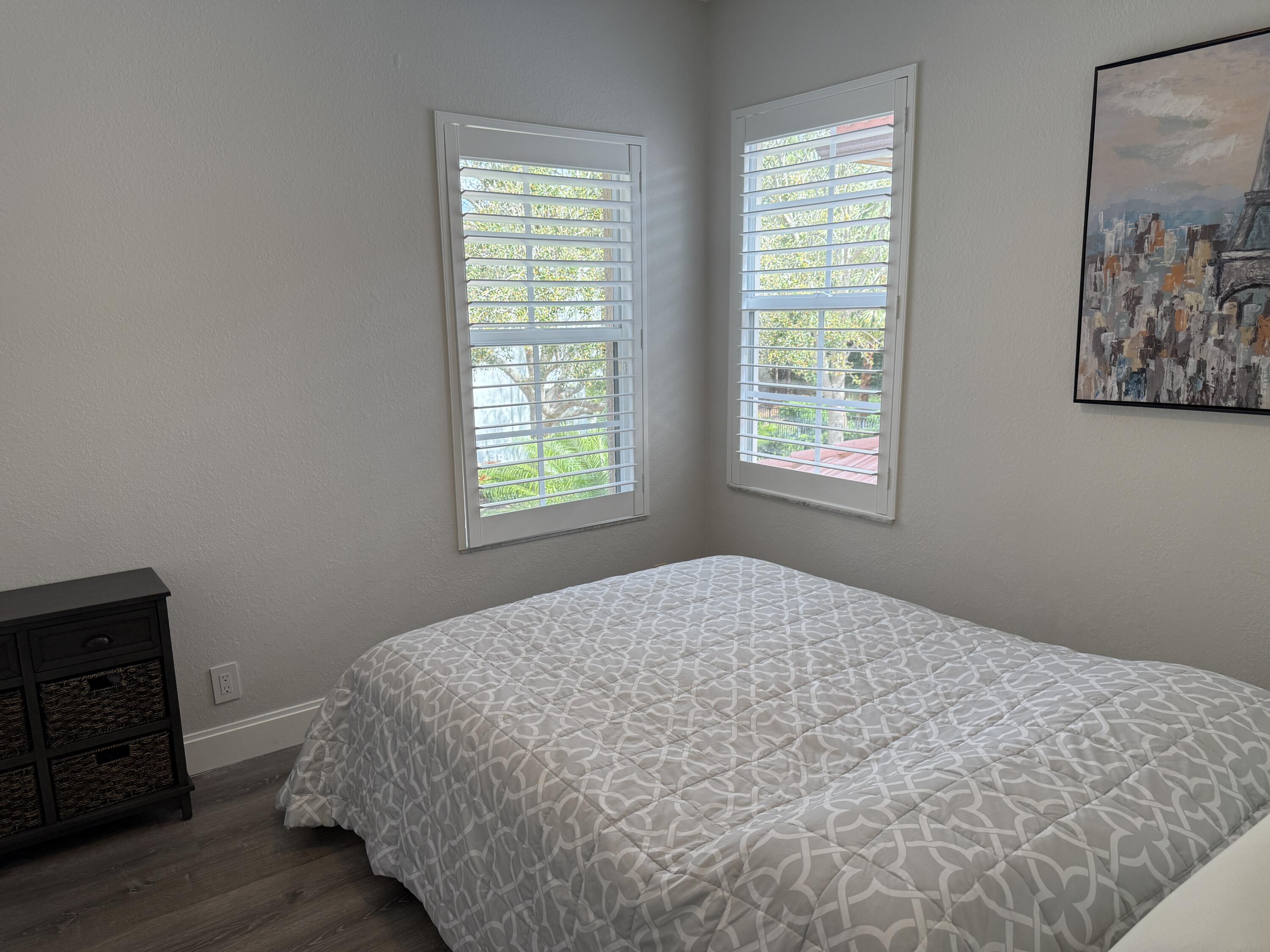 706 Duchess Court Palm Beach Gardens, FL 33410 - Photo 18 of 61 a bedroom with a bed and a window