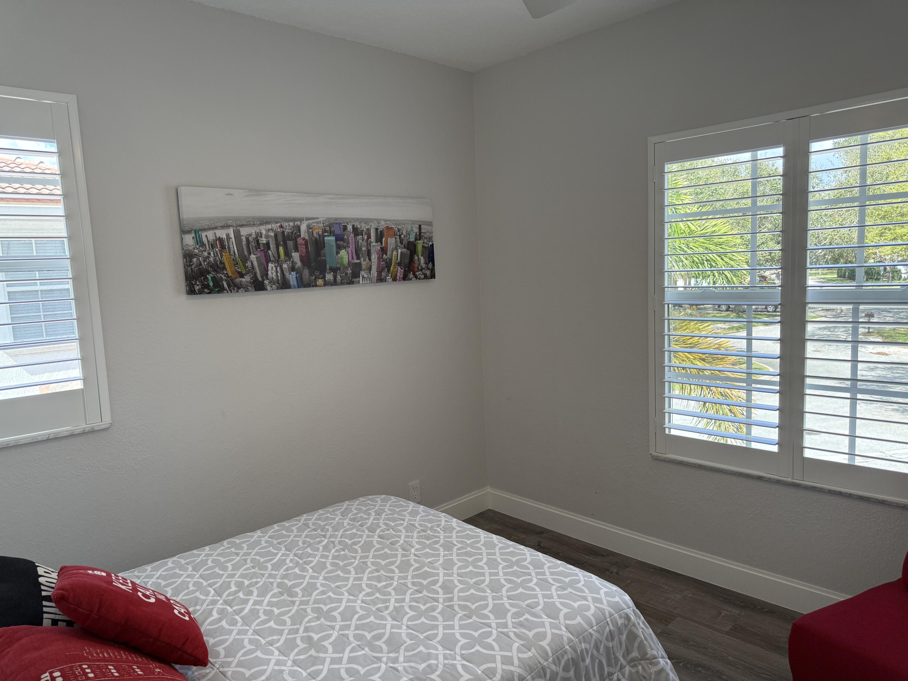 706 Duchess Court Palm Beach Gardens, FL 33410 - Photo 19 of 61 a bedroom with a bed and a window