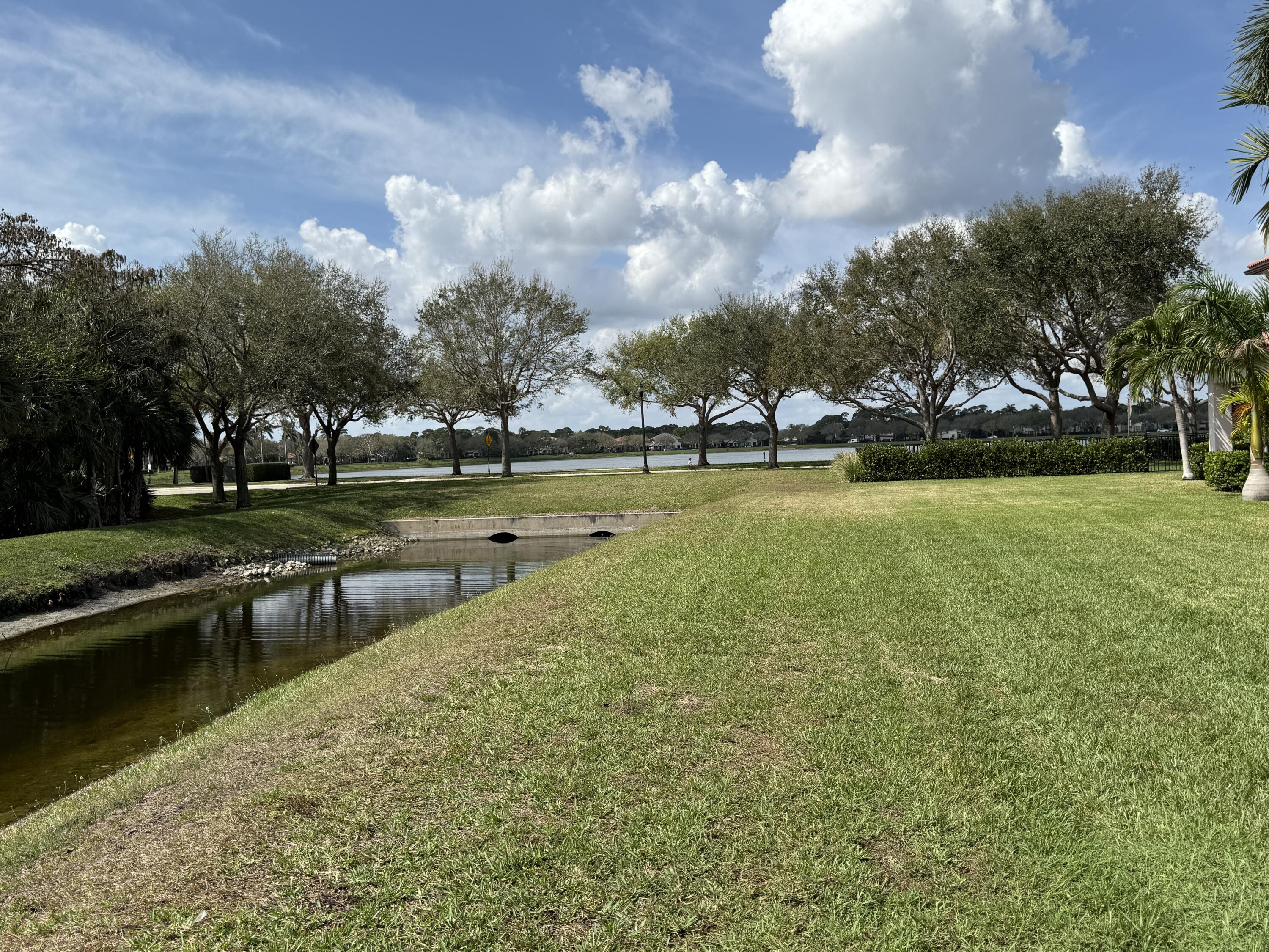706 Duchess Court Palm Beach Gardens, FL 33410 - Photo 24 of 61 a view of a lake with houses in the background