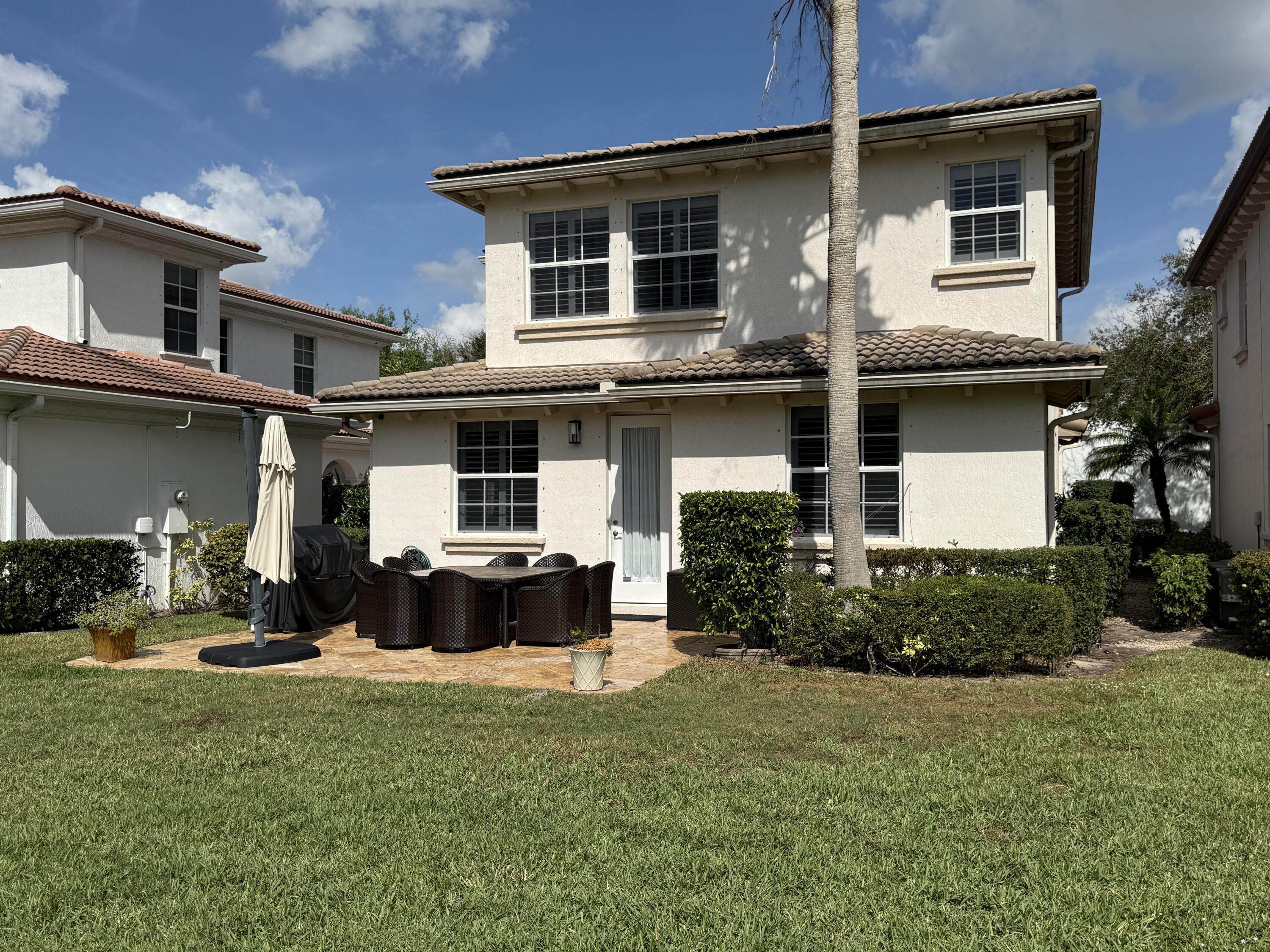 706 Duchess Court Palm Beach Gardens, FL 33410 - Photo 25 of 61 a front view of a house with a yard