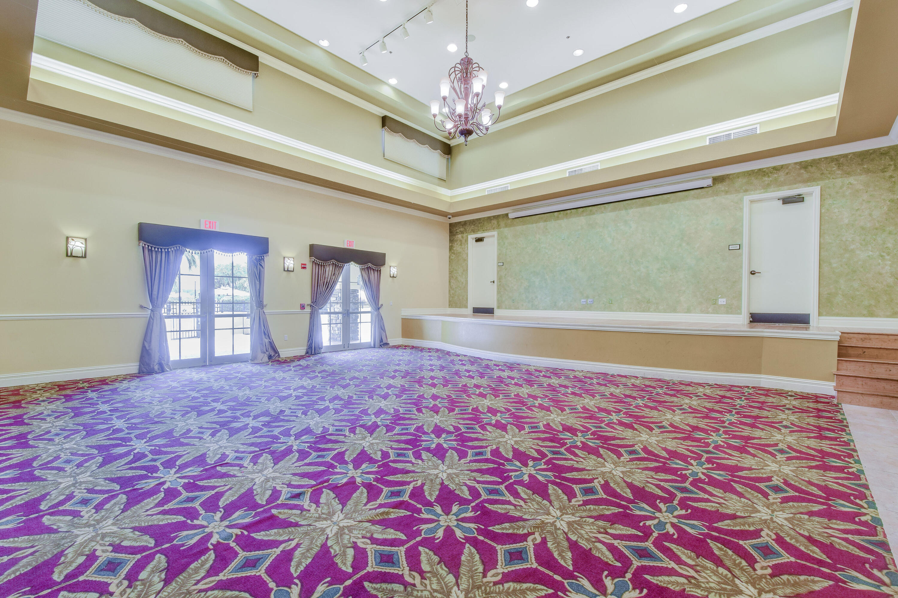 706 Duchess Court Palm Beach Gardens, FL 33410 - Photo 40 of 61 a big room with windows and chandelier