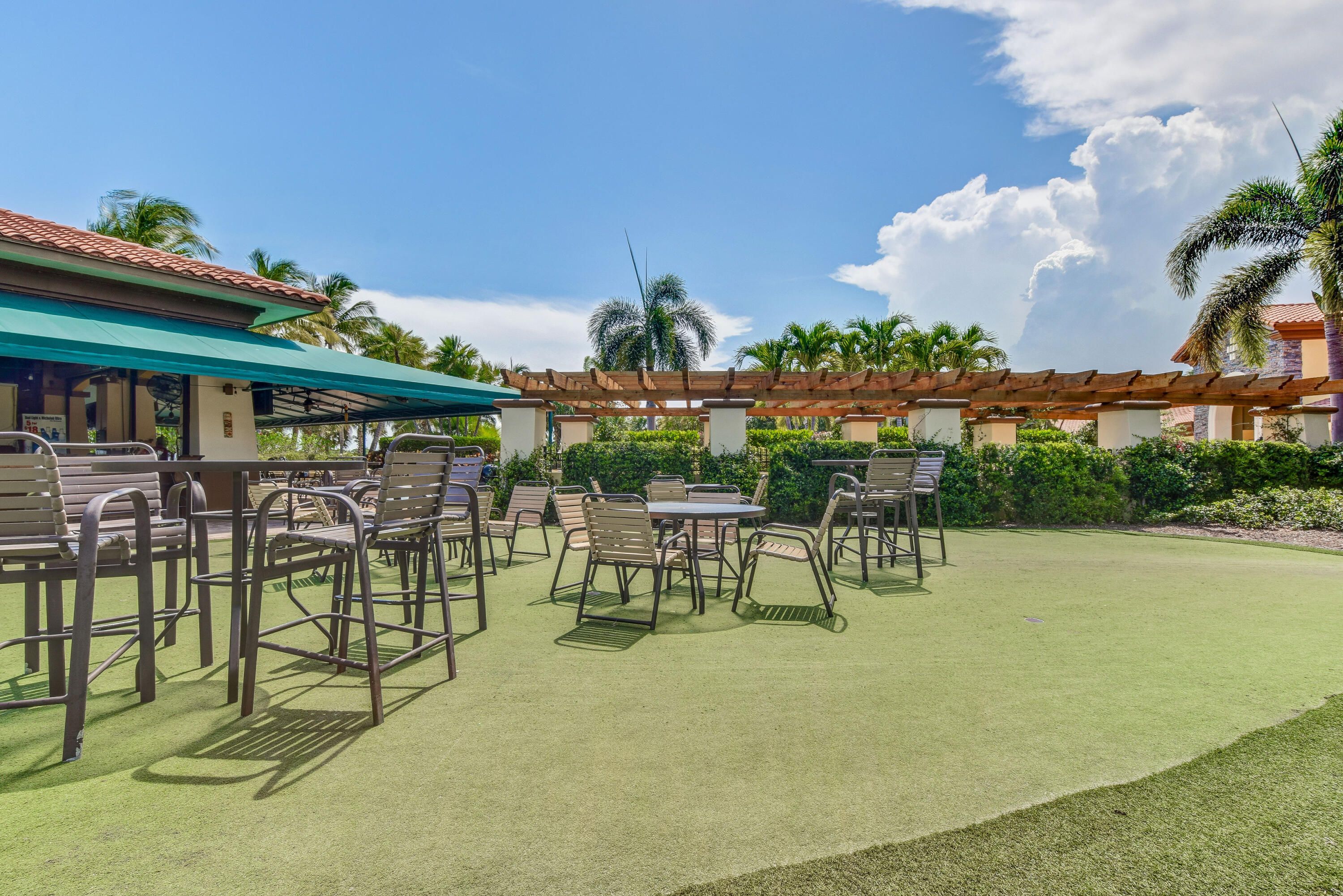 706 Duchess Court Palm Beach Gardens, FL 33410 - Photo 46 of 61 a view of a chairs and table in patio