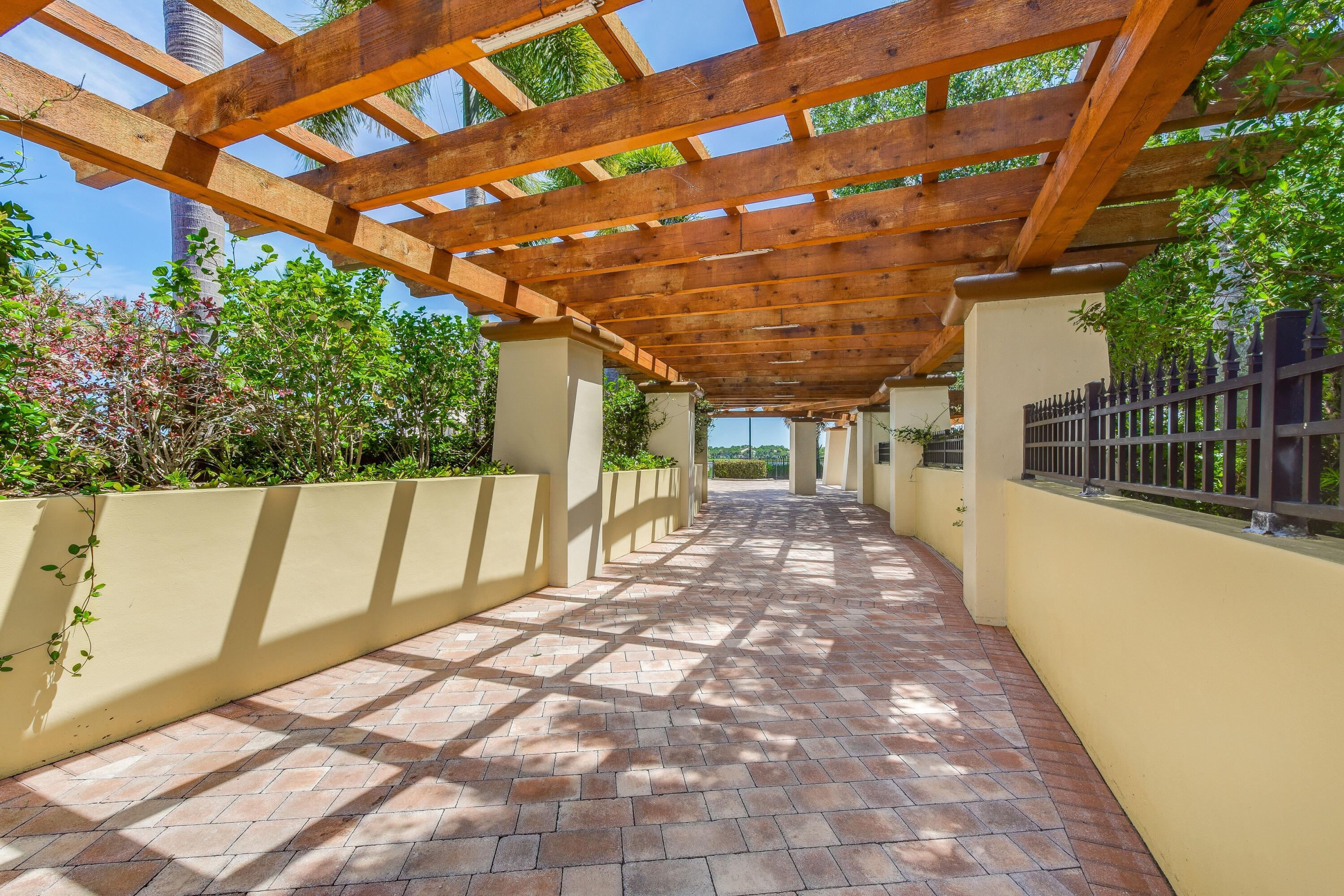 706 Duchess Court Palm Beach Gardens, FL 33410 - Photo 50 of 61 a porch with a table and chairs next to a yard