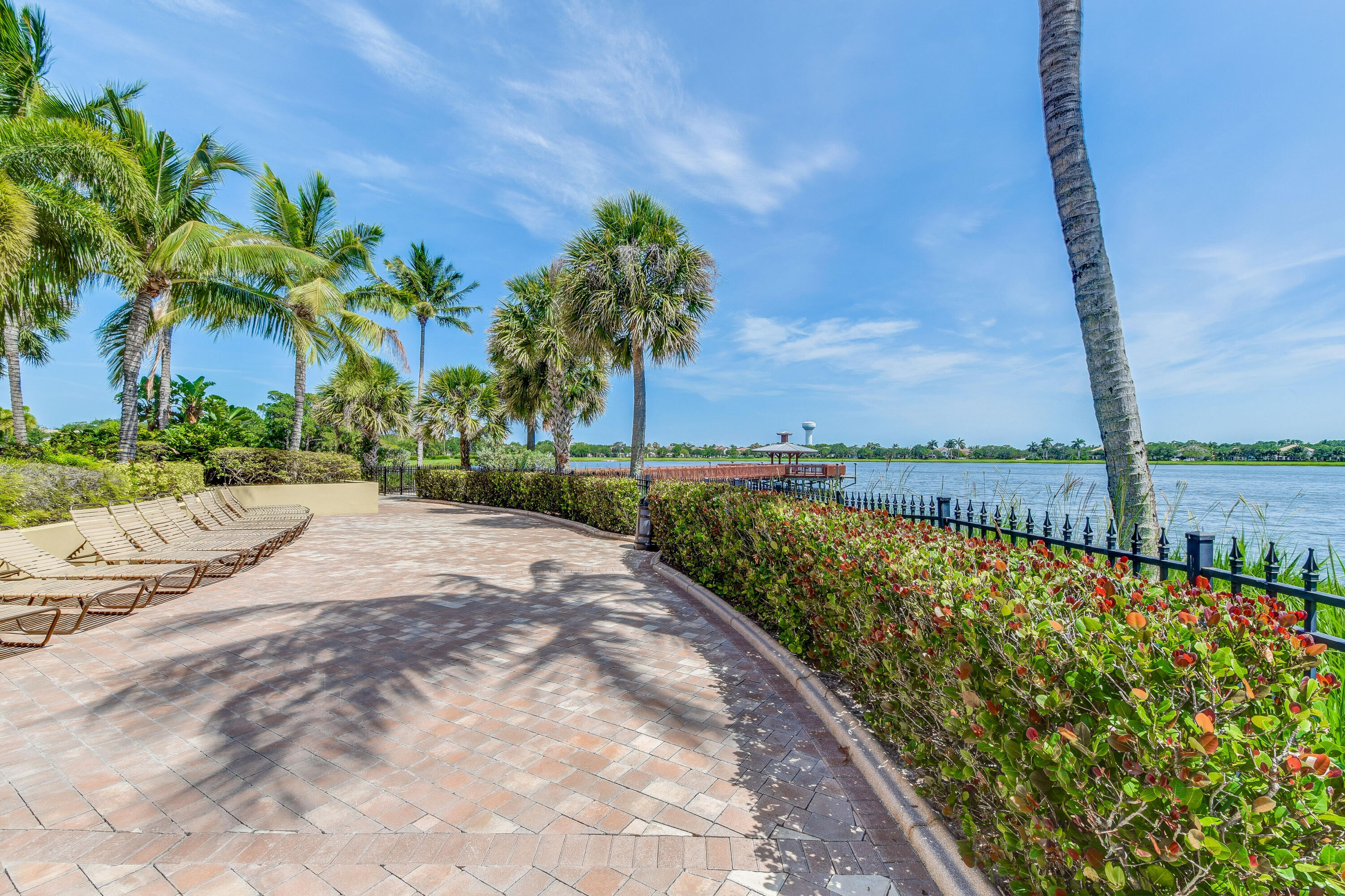 706 Duchess Court Palm Beach Gardens, FL 33410 - Photo 52 of 61 a view of swimming pool with a yard and palm trees