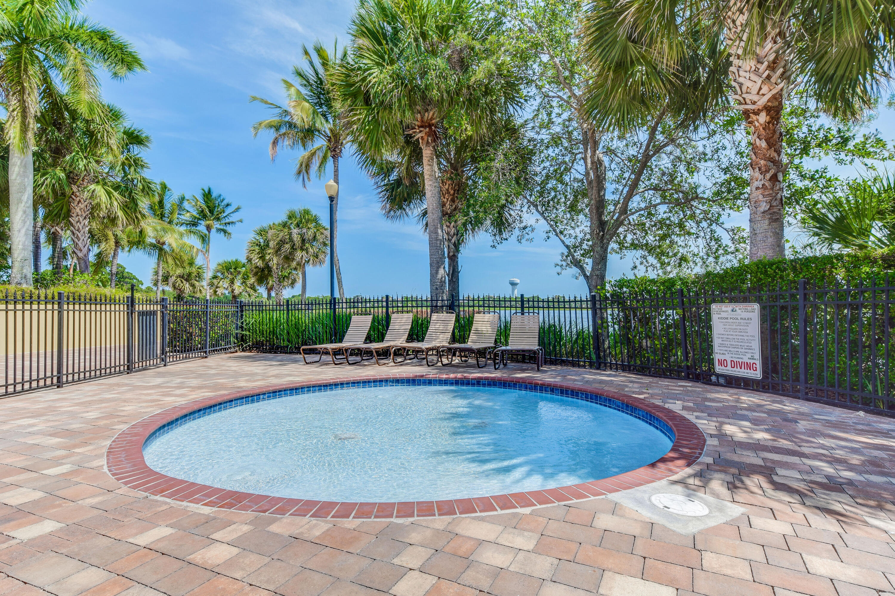 706 Duchess Court Palm Beach Gardens, FL 33410 - Photo 53 of 61 a view of a swimming pool and trees