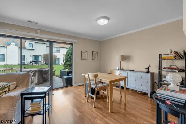 a dining room with furniture and wooden floor