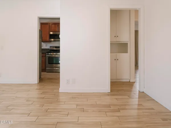 a view of empty room with wooden floor