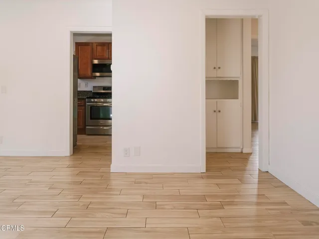 a view of empty room with wooden floor