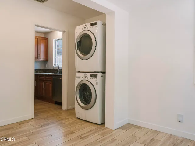 a utility room with washing machine and a view of bedroom