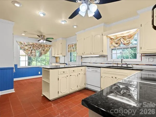 a kitchen with stainless steel appliances granite countertop a stove a sink and a granite counter tops