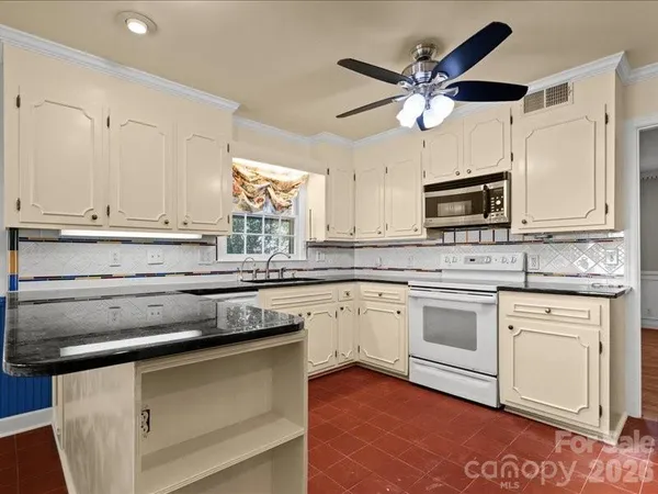 a kitchen with appliances cabinets and a window