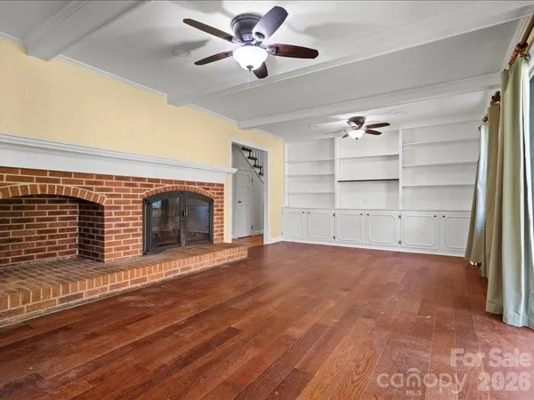 wooden floor in an empty room with a fireplace