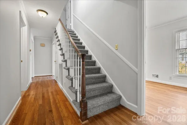 a view of a hallway with wooden floor and entryway