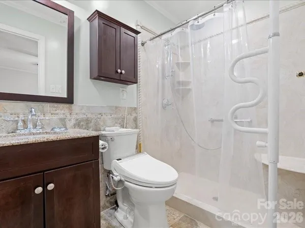 a bathroom with a sink toilet and shower