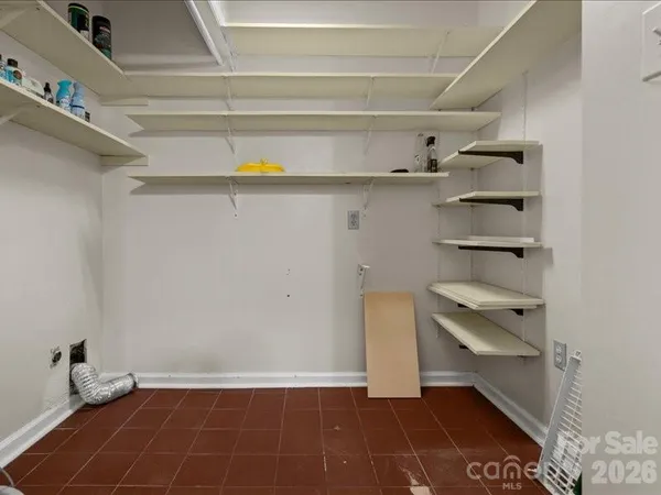 a view of storage and utility room with racks on the wall