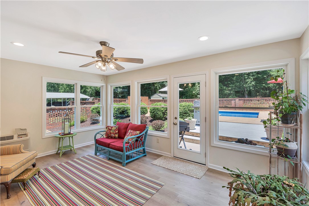 910 Chantilly Lane Anderson, SC 29625 - Photo 29 of 38 A vibrant sunroom with ample windows offers tranquil views of the private outdoor pool and lush landscaping.
