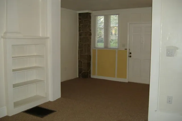 a view of an empty room with a window