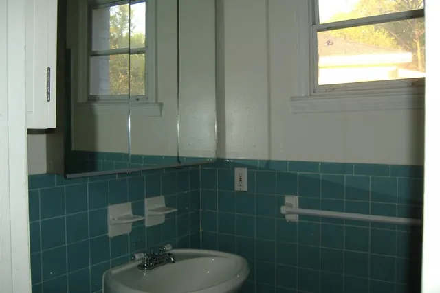 a bathroom with a sink and a window