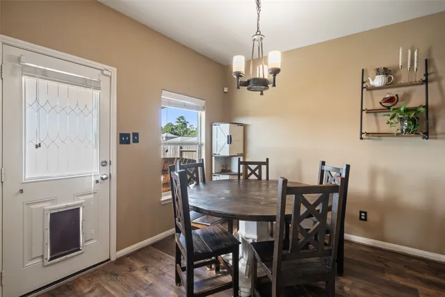 a view of a dining room with furniture wooden floor and a chandelier