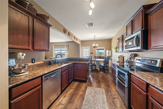 a kitchen with lots of counter top space and appliances