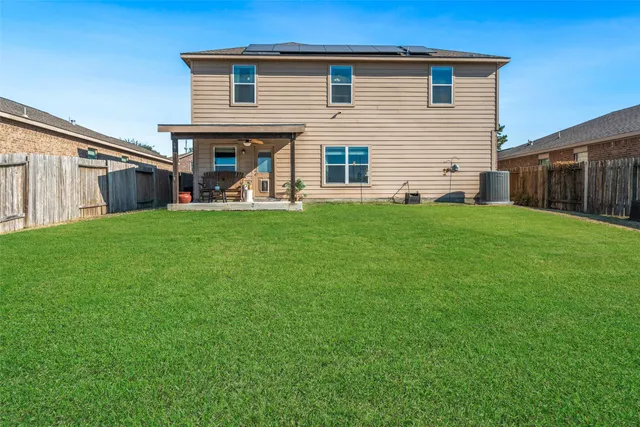 a view of a house with a backyard