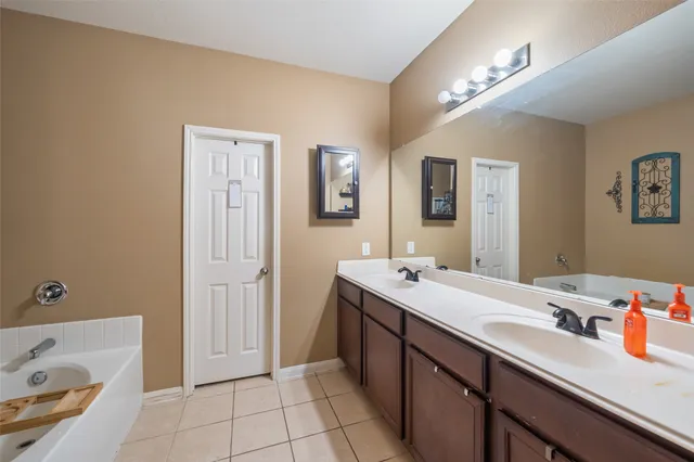 a bathroom with a sink double vanity and a tub