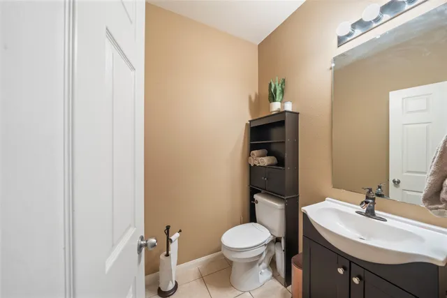 a bathroom with a sink a toilet and mirror