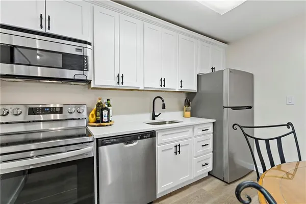 a kitchen with stainless steel appliances granite countertop a stove and a refrigerator
