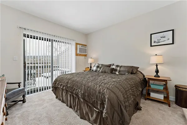 a bedroom with a bed next to a window