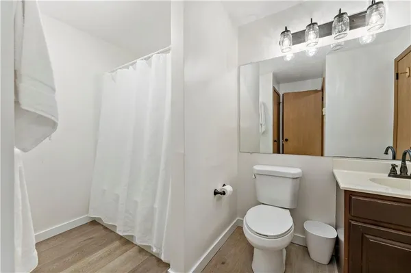 a bathroom with a toilet a sink and view