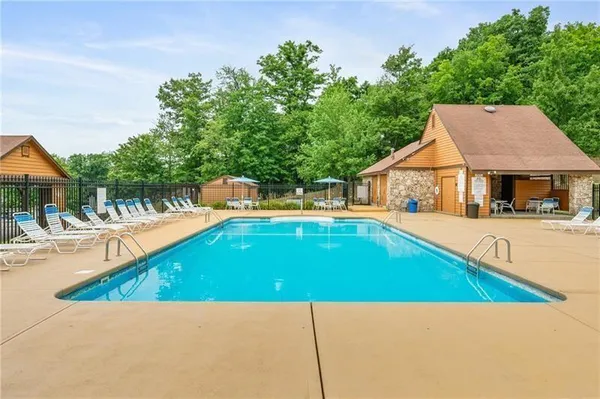 a swimming pool with outdoor seating and yard