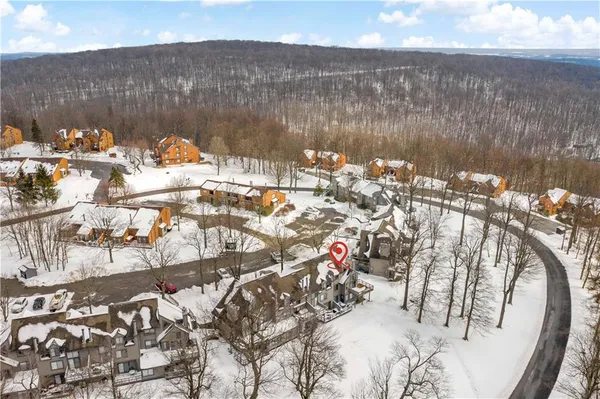 a view of a house with snow on the road