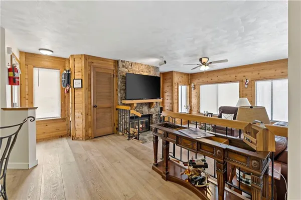 a living room with furniture a flat screen tv and large window